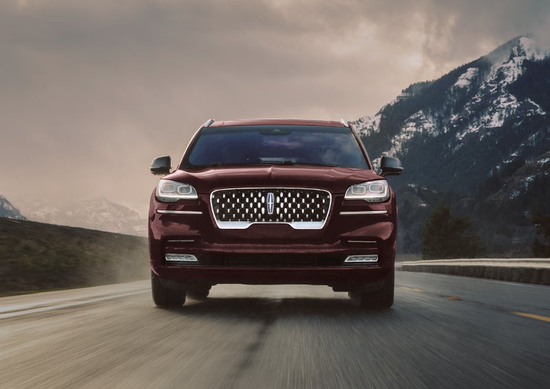 A 2023 Lincoln Aviator® Grand Touring model is shown being driven in a river valley.
