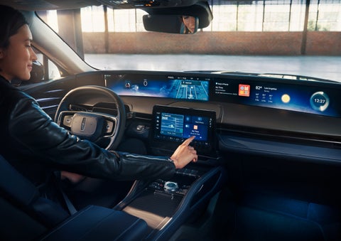 The driver of a 2024 Lincoln Nautilus® SUV interacts with the center touchscreen. | Purchase Lincoln in Mayfield KY