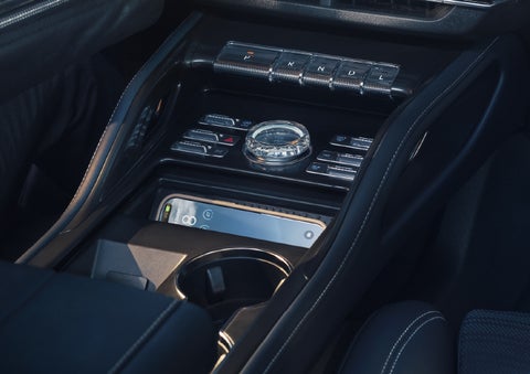 A smartphone is shown charging in the wireless charging pad. | Purchase Lincoln in Mayfield KY